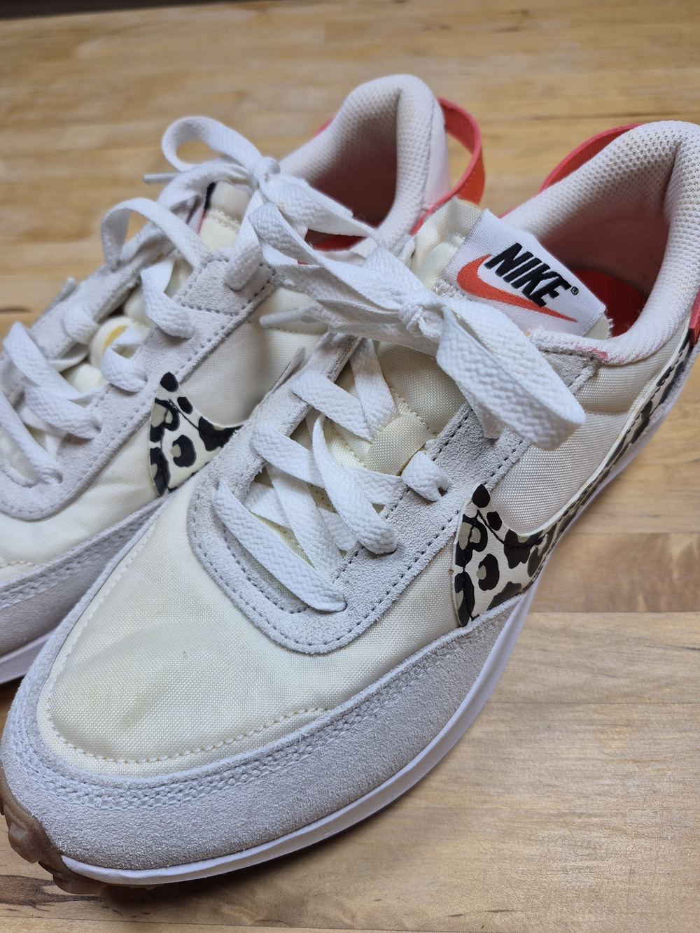 Nike Cream Athletic Sneakers with Leopard Swoosh and Orange Trim